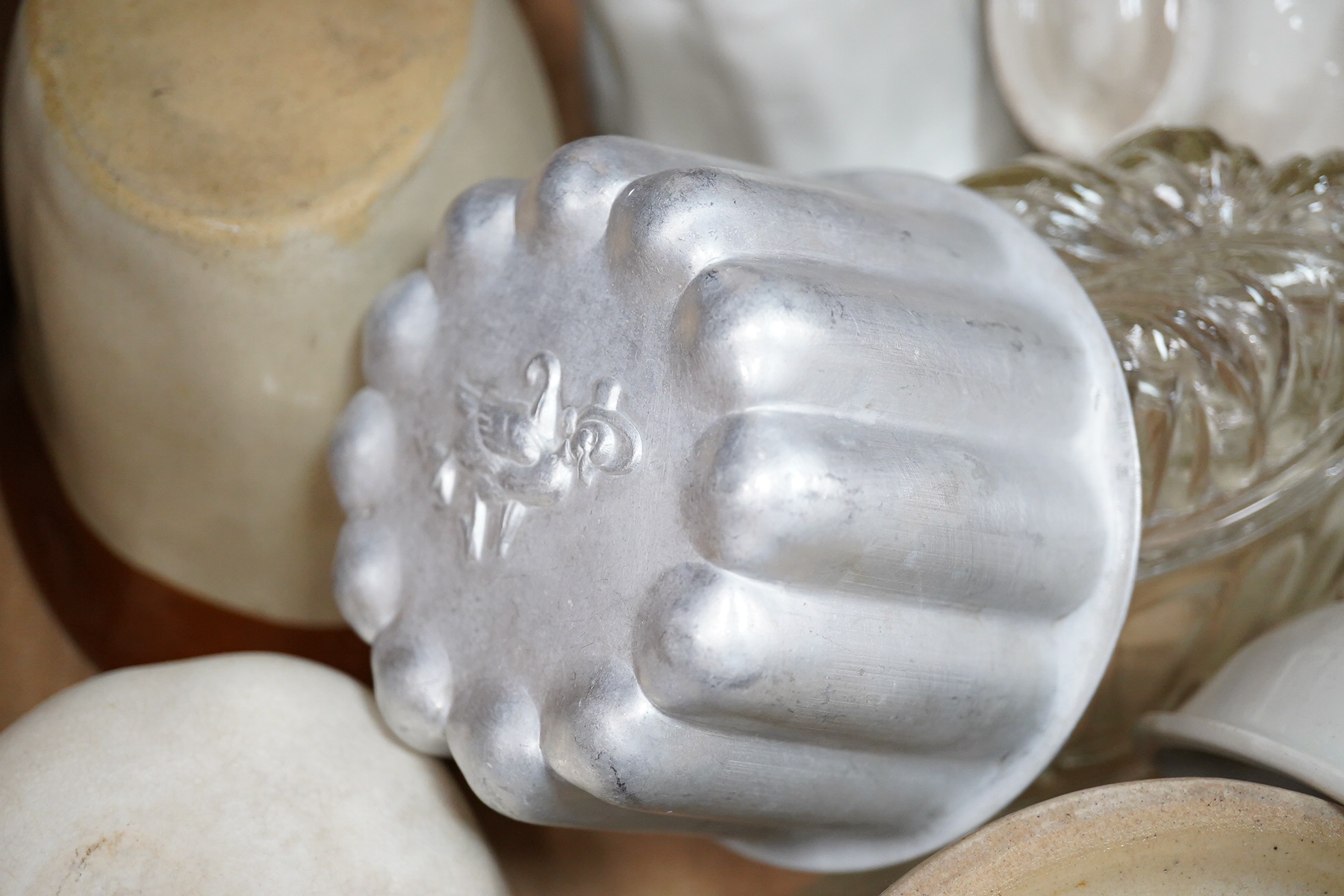 A collection of mostly Victorian ceramic and later glass and metal jelly moulds